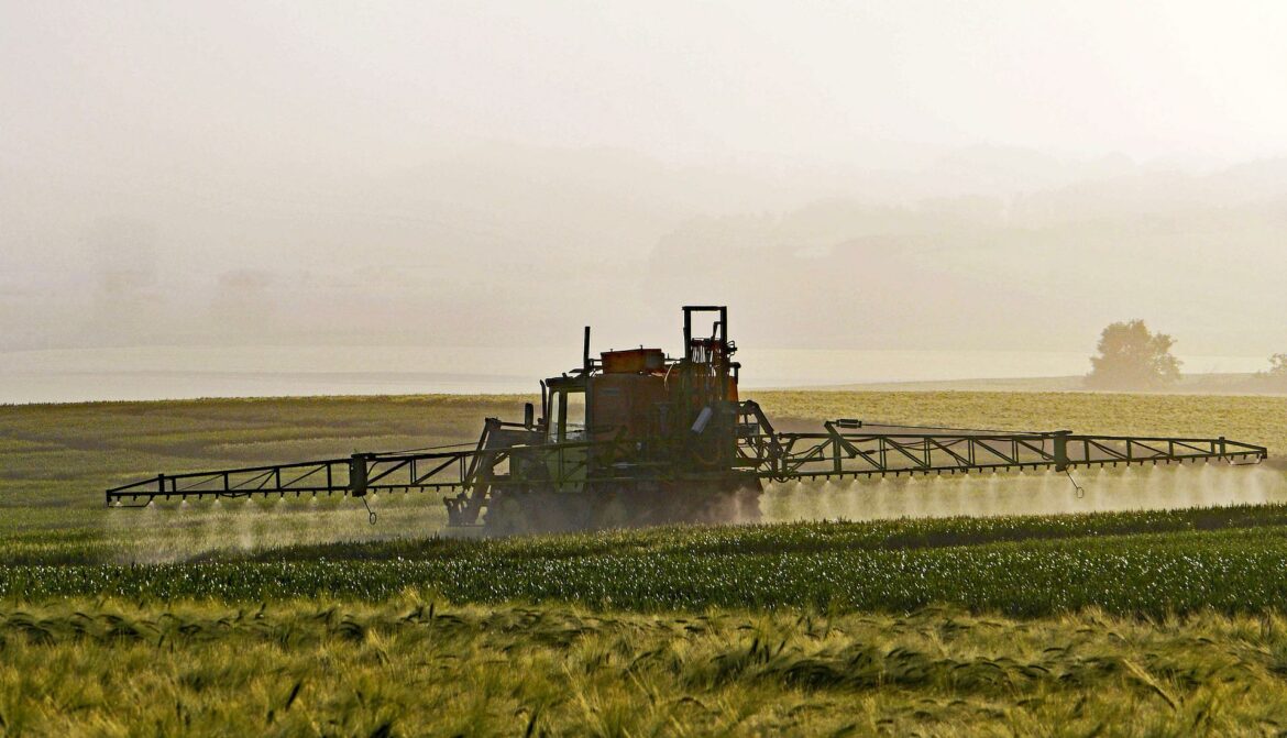 Agriculture machine spraying pesticides on crops